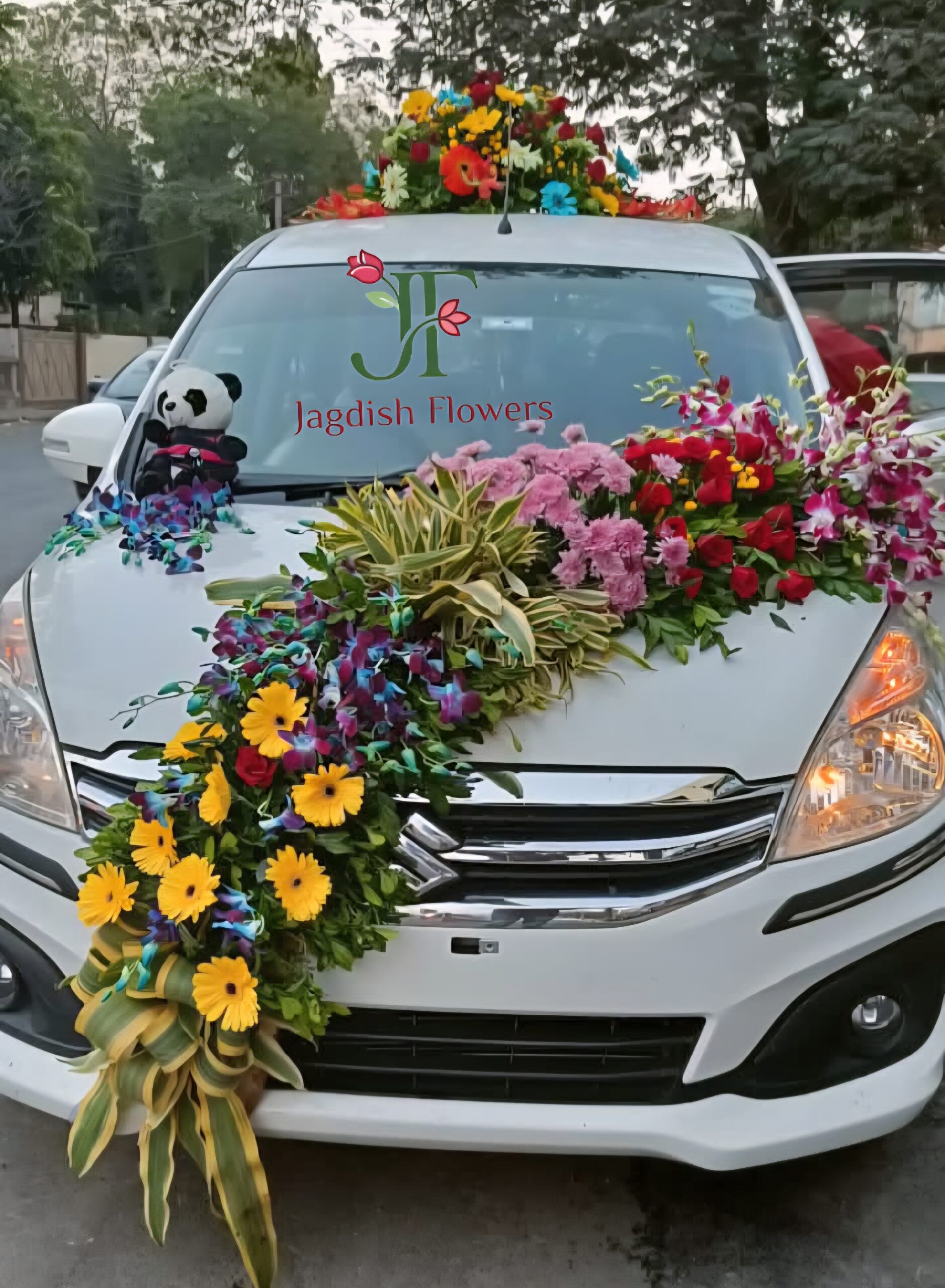 Colorful wedding car decoration with mixed fresh flowers for Indian weddings