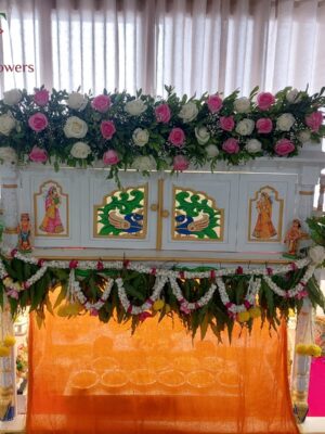 Elegant home temple flower decoration with fresh floral arrangements for pooja ceremonies