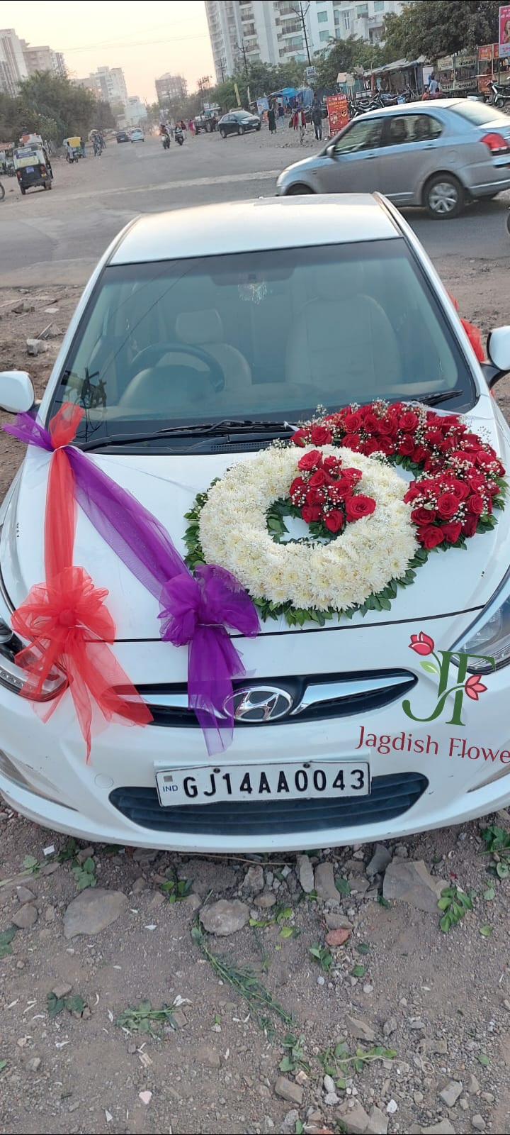 Elegant red rose wedding car decoration with fresh flowers for Indian weddings