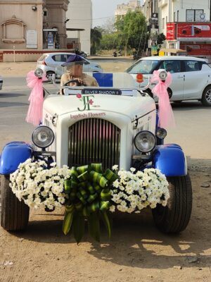 Vintage wedding car decoration with fresh white flowers for bridal entry car