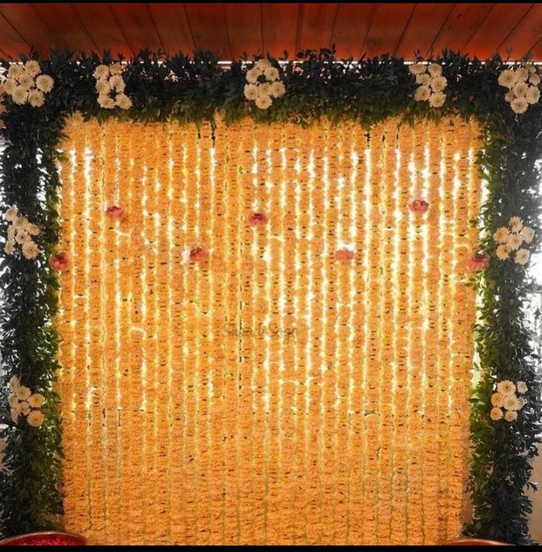 Traditional wedding flower stage decoration with floral garlands