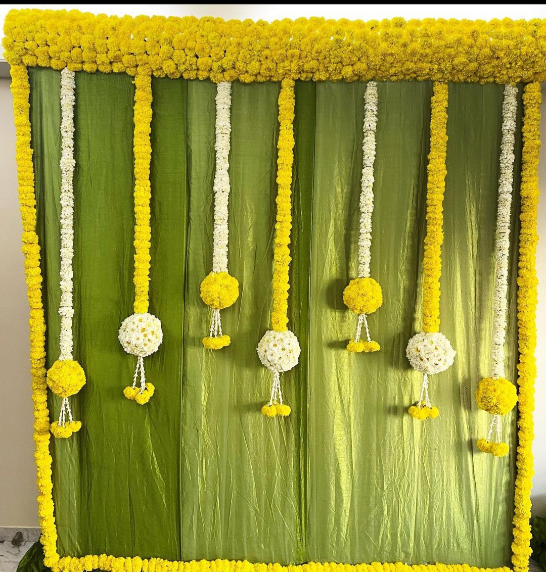 Designer floral backdrop decoration with marigold flowers for weddings