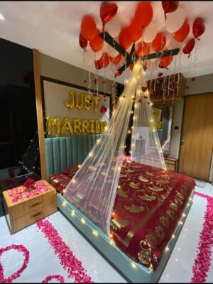 Premium honeymoon room decoration with fresh flowers and romantic bed styling