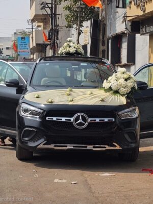 Premium white rose wedding car decoration with fresh flowers and elegant floral styling
