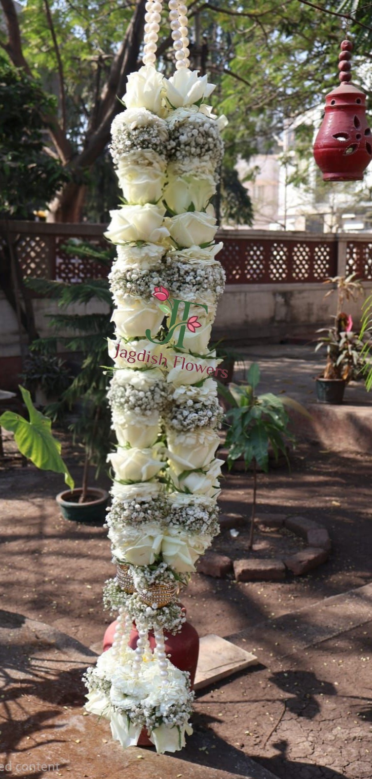 Traditional wedding garland with fresh floral styling