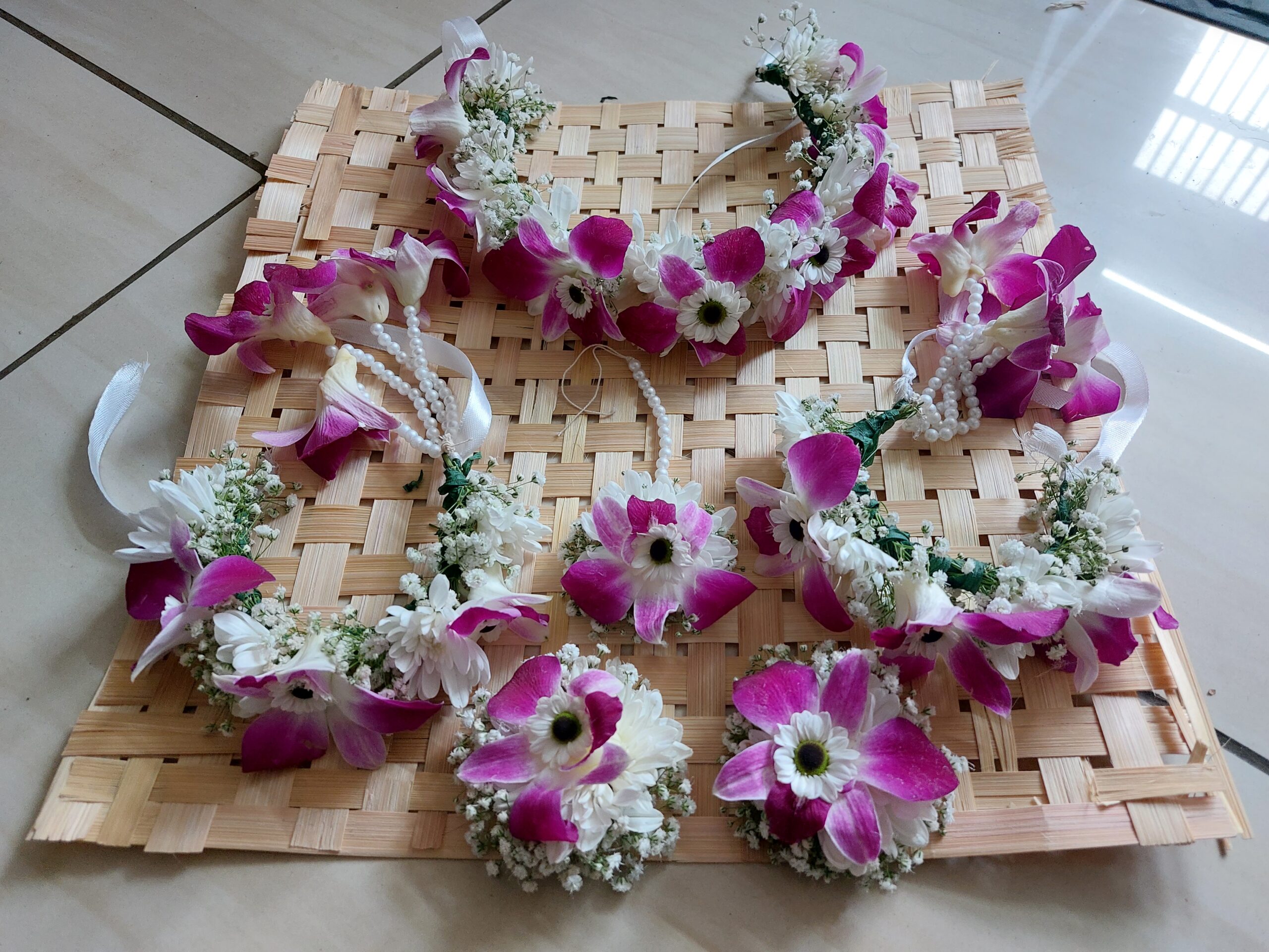 Handcrafted purple orchid, white Sevanti, and Gypsophila floral jewellery set with necklace, earrings, maang tikka, bracelet, and hair accessories for Haldi and Mehndi in Rajkot